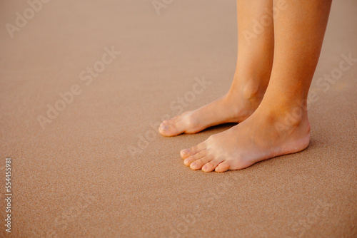 feet on the beach, feet on golden sand. 
