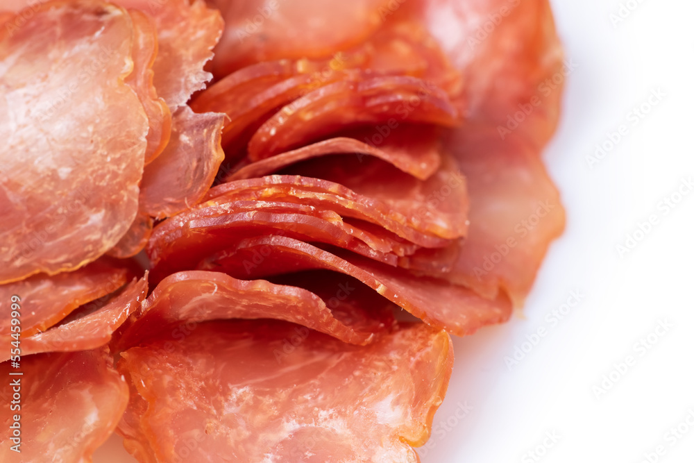 Sliced and jerky meat isolated on a white background. Pile of beef jerky pieces.