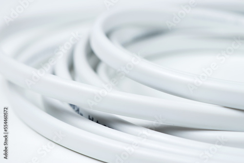 closeup of a white electric cable on a white background