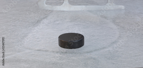 Photography black hockey puck on ice