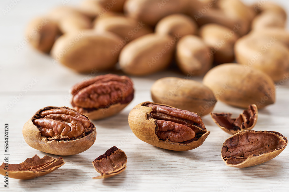 Obraz premium Pecan on a white kitchen table, selective focus.