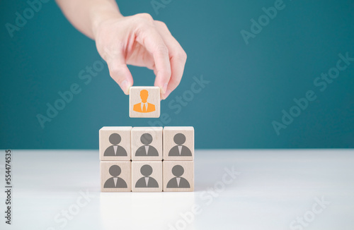 human resource management or HRM, male hand holding wooden block focus on manager icon, business one of employee icons for leadership service, leading organization in recruiting and prospecting