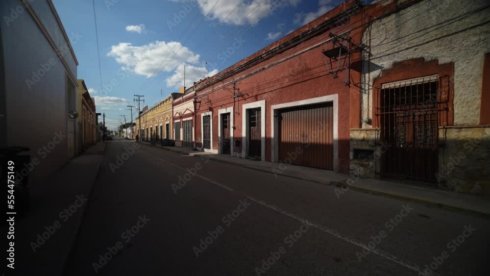 Slow motion push in down a deserted street in Mexico, Merida, Yucatan in early evening.