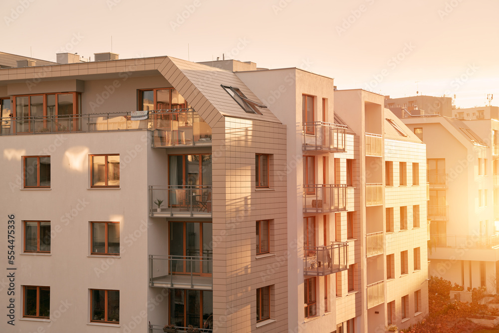 Sunset in modern low-rise flat house district. European contemporary real estate with loft flats.