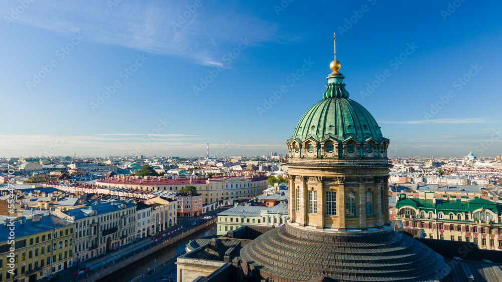 Aerial front, up view of the enter dome and colonnade of the Kazan Cathedral in the historical city of St. Petersburg at sunny summer dawn