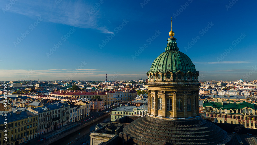 Aerial front, up view of the centre enter dome and colonnade of the Kazan Cathedral in the historical city of St. Petersburg at sunny summer dawn