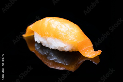 Delicious sushi nigiri with salmon sake isolated on black background. Japanese traditional cuisine photo