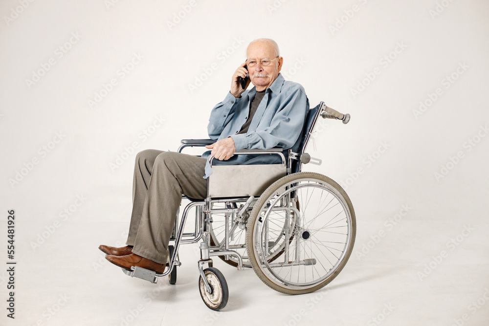 Portrait of an old man on a wheelchair isolated on a white background Portrait of an old man on a wheelchair isolated on a white background