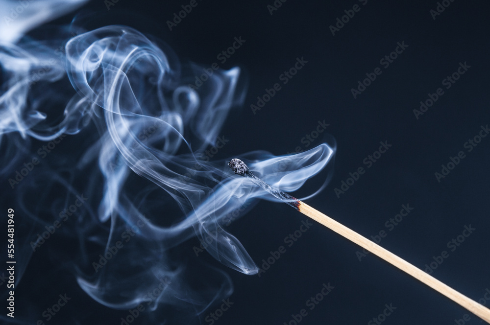Burnt matchstick with smoke on a dark background Burnt matchstick with smoke on a dark background