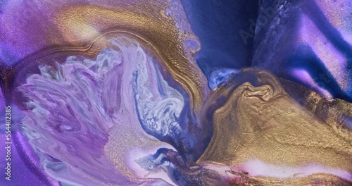 Lilac gold ink shiny splash current background. Beautiful abstract paint flow. Purple blue gold color fluid art mix. Golden glitter liquid in motion. Creative texture, pattern