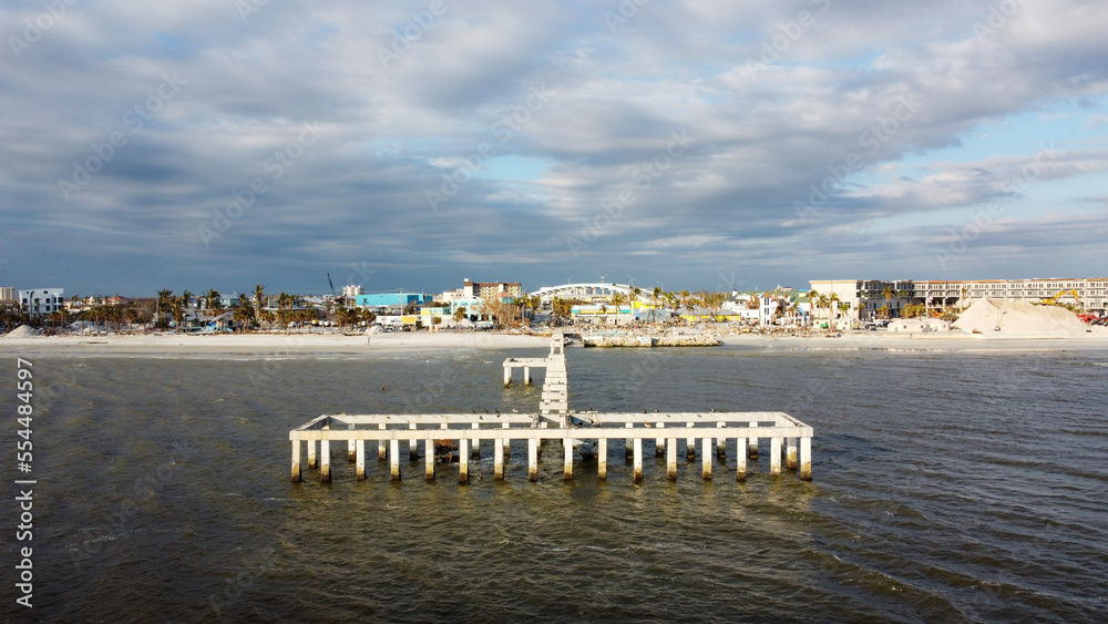A month after Hurricane Ian brought historic winds and storm surge to the island of Fort Myers Beach, rubble still sits in piles near the shore. 