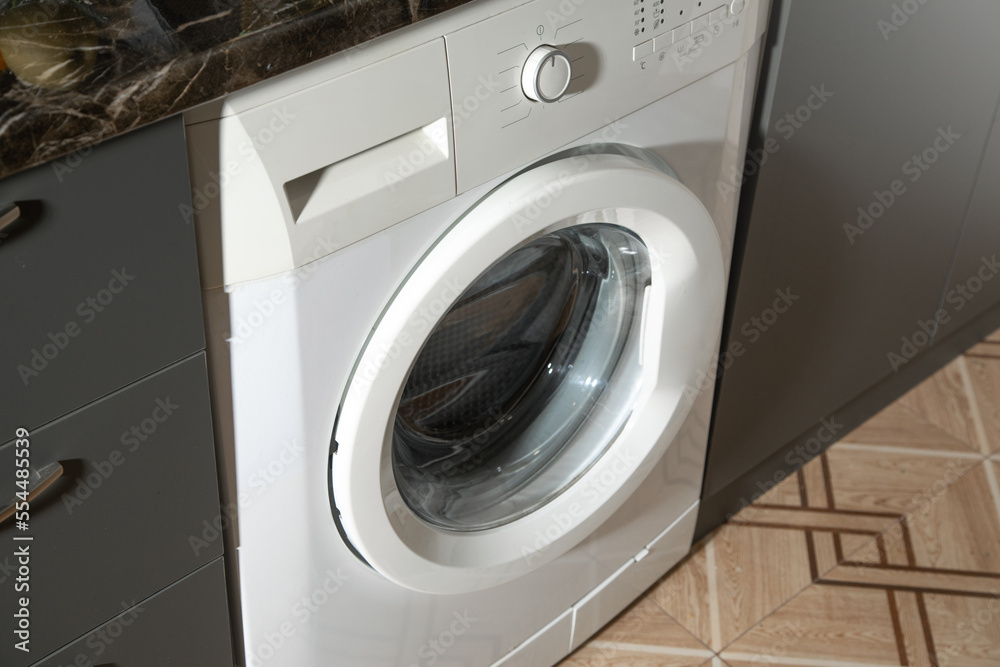 White washing machine at home. White washing machine at home.