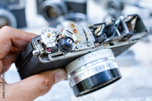 Close up hand of male technician holding and repairing camera