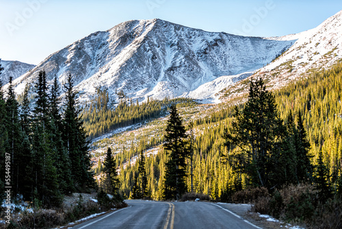 Independence Pass at winter snow Rocky mountain view by paved road scenic byway in morning sunrise near Aspen, Colorado in green autumn winter photo