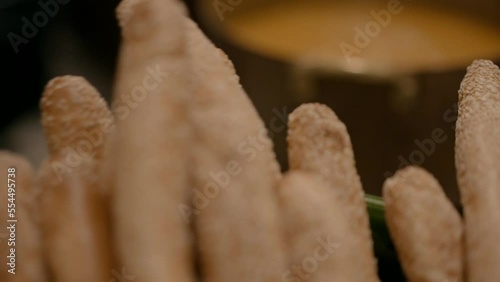 Hot soup in a cooking pot ready to be served with bread on the table next to it. A close-up shot in the kitchen photo