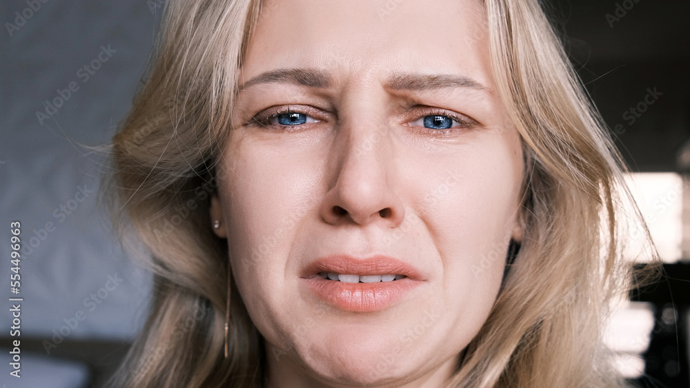 Portrait of crying grieving woman of 30 years. Grimace of sadness with tears in her eyes and crooked chin of blonde woman looking at camera. Emotional swing, unstable psyche, mental problems Portrait of crying grieving woman of 30 years. Grimace of sadness with tears in her eyes and crooked chin of blonde woman looking at camera. Emotional swing, unstable psyche, mental problems