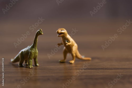 Toy dinosaurs on wooden surface