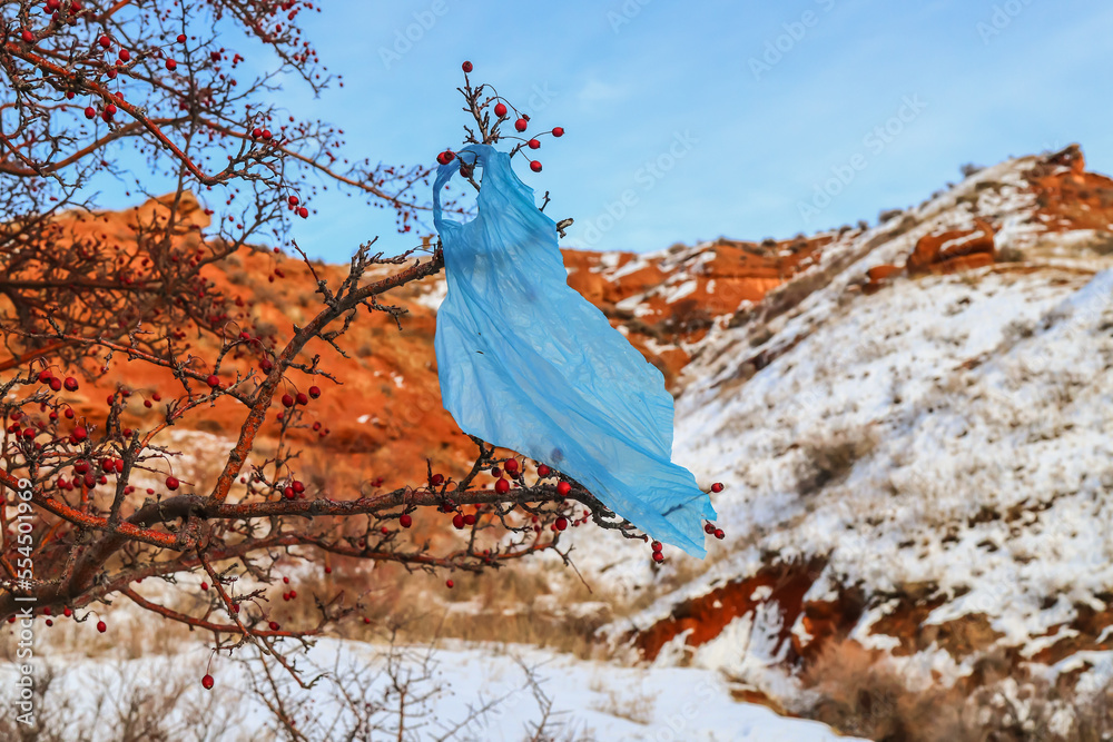 Cellophane bag trash on a tree in nature