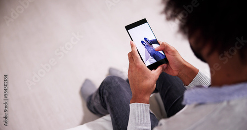 Man Trying Virtual Sneakers In Shop