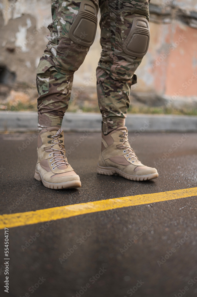 A soldier shod in special tactical khaki shoes A soldier shod in special tactical khaki shoes