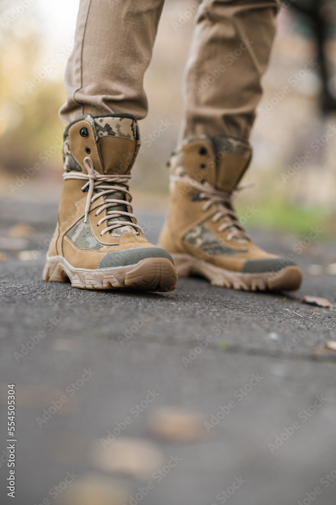 Leather waterproof boots on military. Demi-season high boots of khaki color Leather waterproof boots on military. Demi-season high boots of khaki color