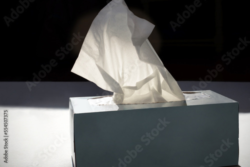 tissue box backlit wih dark background and dramatic light photo