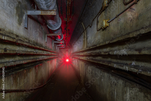 Exploration of an old bunker from the second world war with a red flashlight