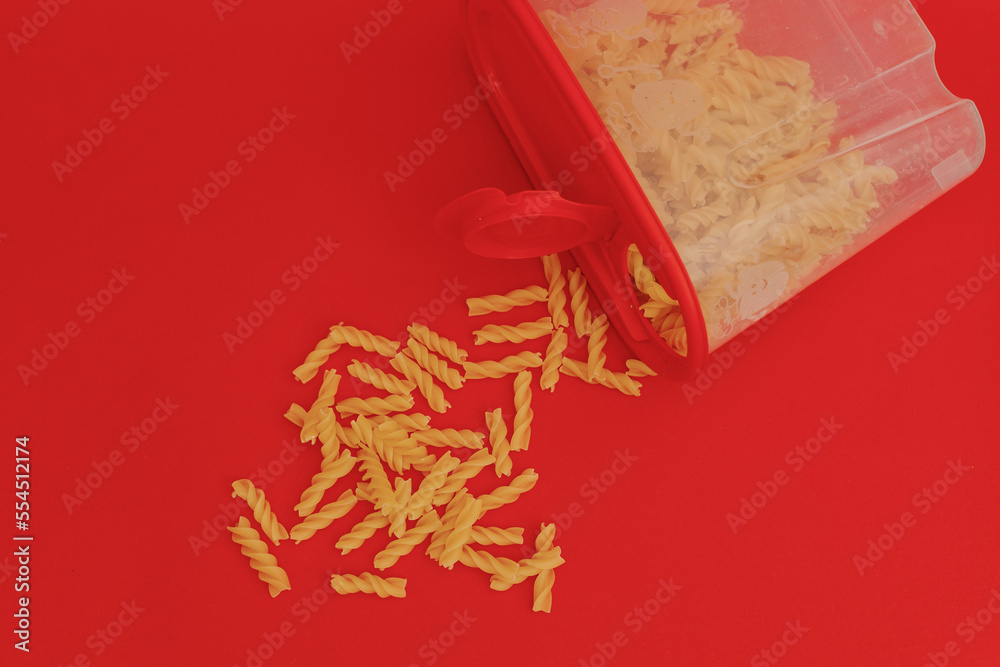 Pasta scattered on a red background