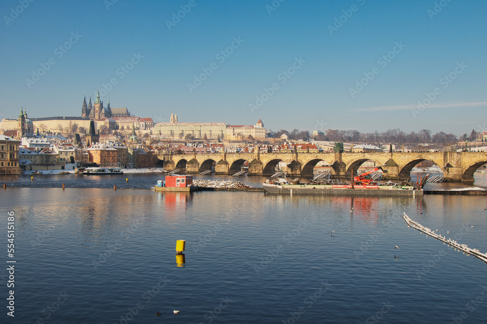 View over Vltava river to Charles bridge, Prague Castle in background.
