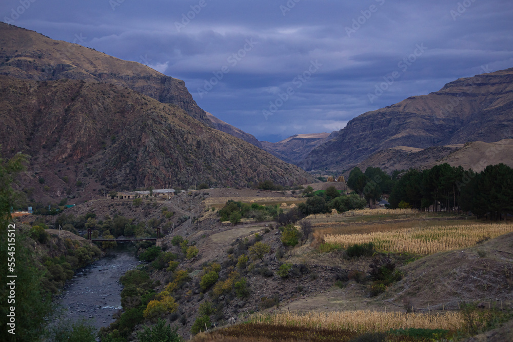 Fototapeta premium mountain and river view, dramatic sky