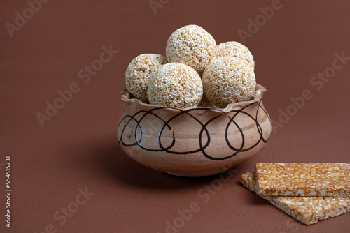 Indian sweet for traditional festival makar sankranti , Rajgira laddu made from Amaranth seed in Bowl on Brown background photo