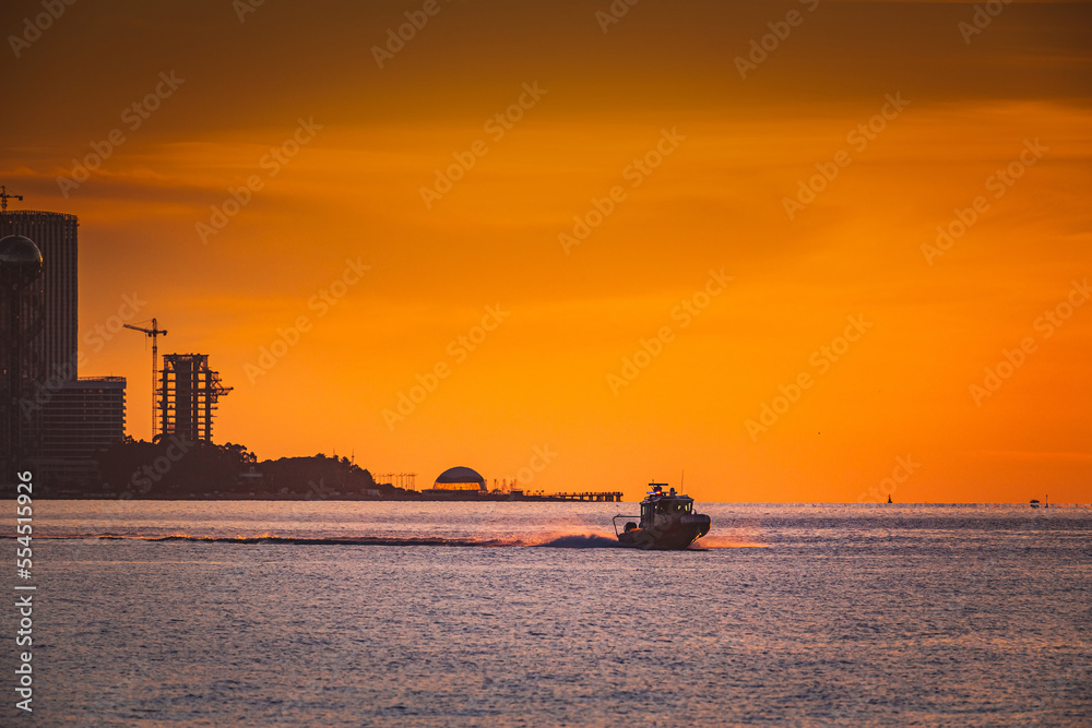 coast guard boat at sea at sunset view from the shore