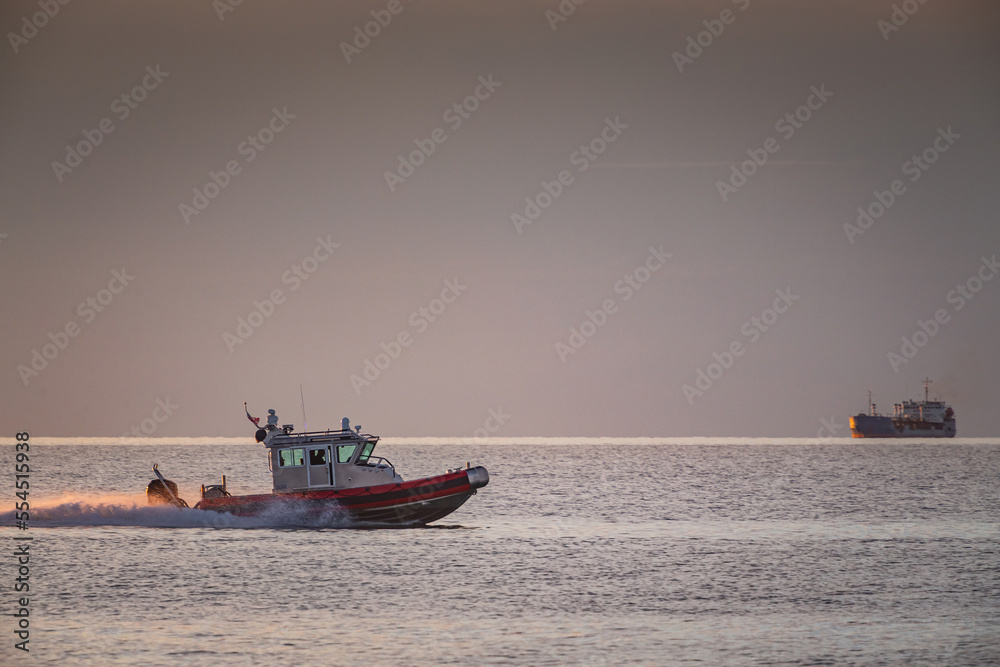 coast guard boat at sea at sunset view from the shore