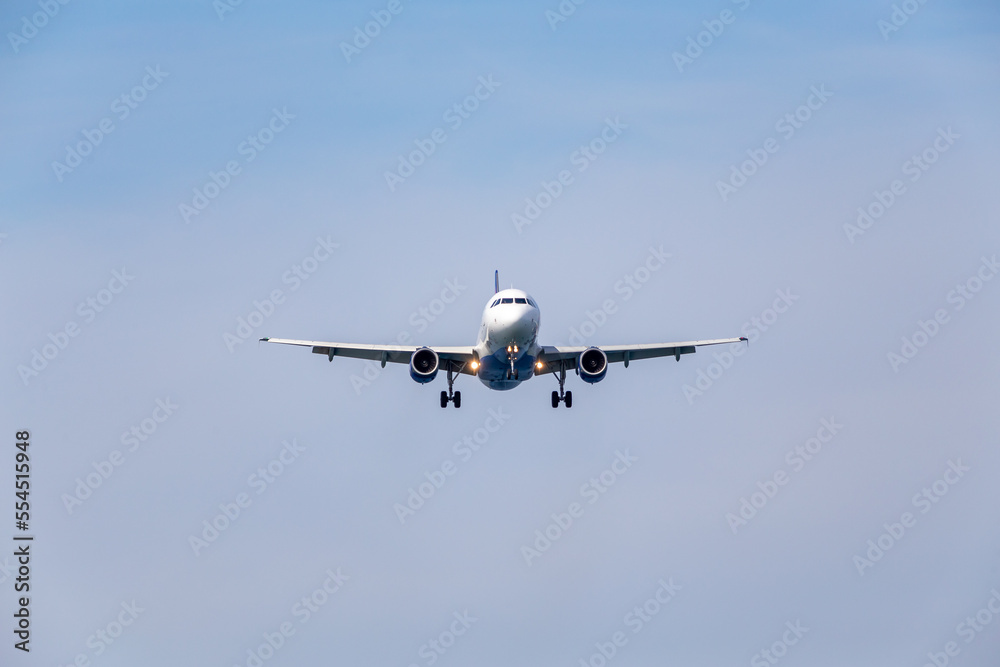 plane in the sky before landing