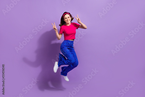 Full length photo of positive lovely lady two arms hands demonstrate v-sign good mood empty space isolated on purple color background