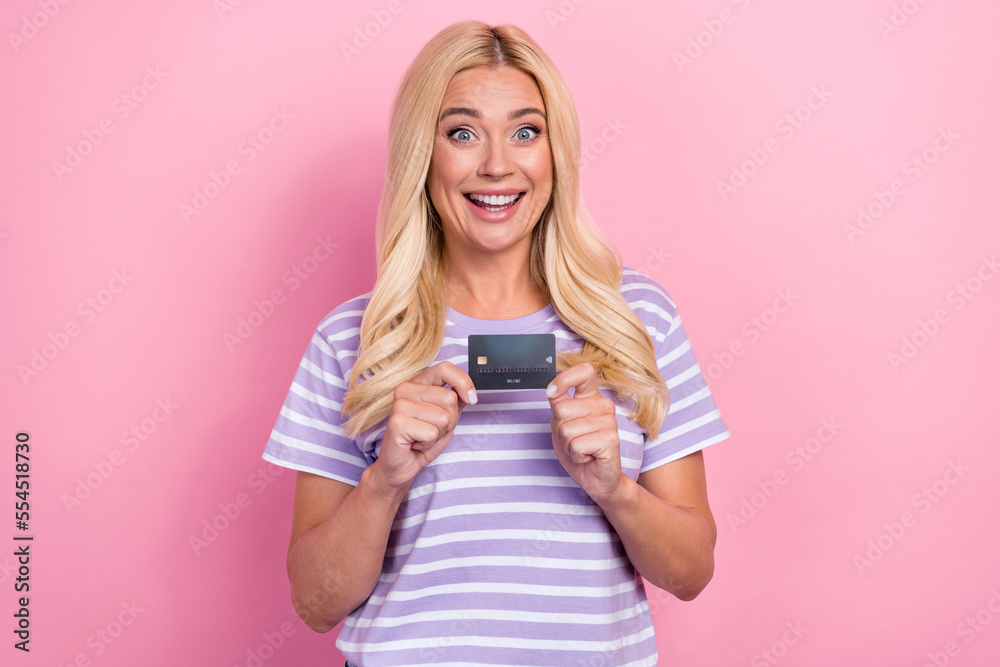 Photo of overjoyed lady blonde hair wear trendy purple striped t-shirt hold plastic credit card enjoy salary day isolated on pink color background Photo of overjoyed lady blonde hair wear trendy purple striped t-shirt hold plastic credit card enjoy salary day isolated on pink color background