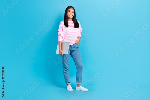 Full body photo of chinese woman hold her new convenient computer wear stylish pink striped jumper enjoy her job isolated on blue color background