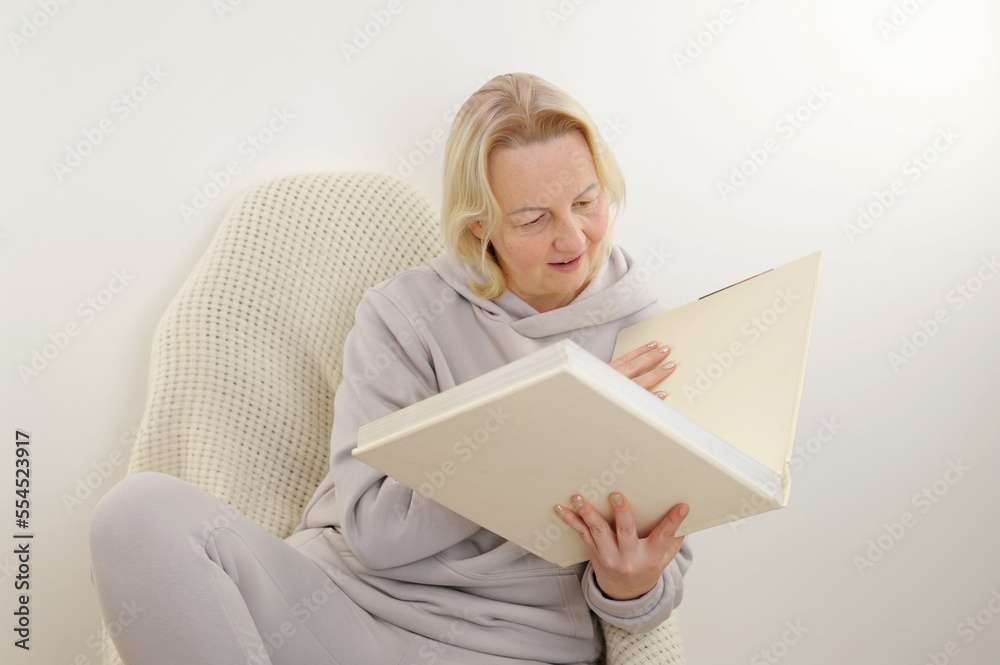 Woman is flipping through an album with blank pages. Woman's hand slowly turns the page of a clean book notebook with beige pages. Looking through a family album of wedding photographs. married woman Woman is flipping through an album with blank pages. Woman's hand slowly turns the page of a clean book notebook with beige pages. Looking through a family album of wedding photographs. married woman