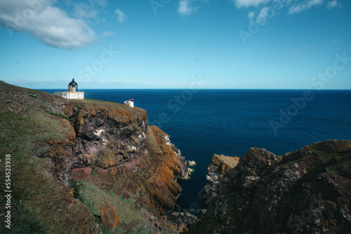The Scottish seashore and the lighthouse on the cliff. St Abb's Head National Nature Reserve on the Berwickshire coastline, Scotland, UK © George
