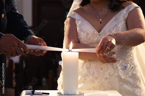 Two candles making one flame at a wedding ceremony