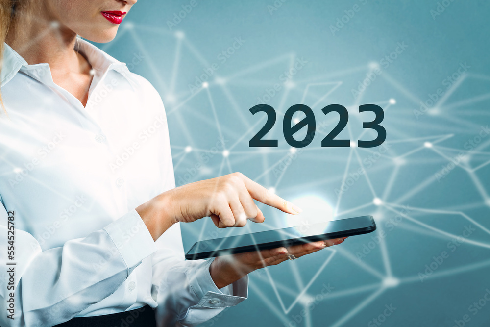2023 text with business woman using a tablet 2023 text with business woman using a tablet