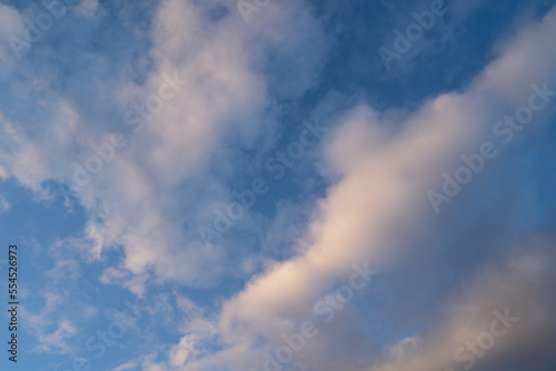 Blue sky with white smoky clouds on a spring evening © Mentor