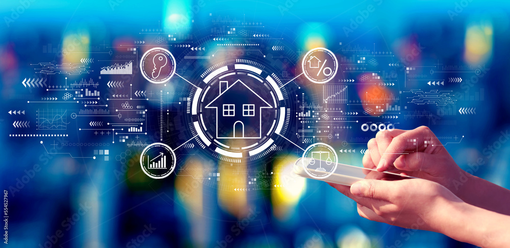 Real estate theme with person using a smartphone in a city at night Real estate theme with person using a smartphone in a city at night