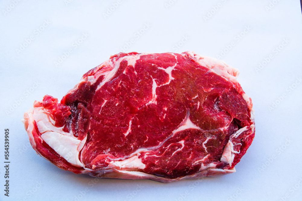 Fresh beef ribeye slice on white background. Fresh beef ribeye slice on white background.