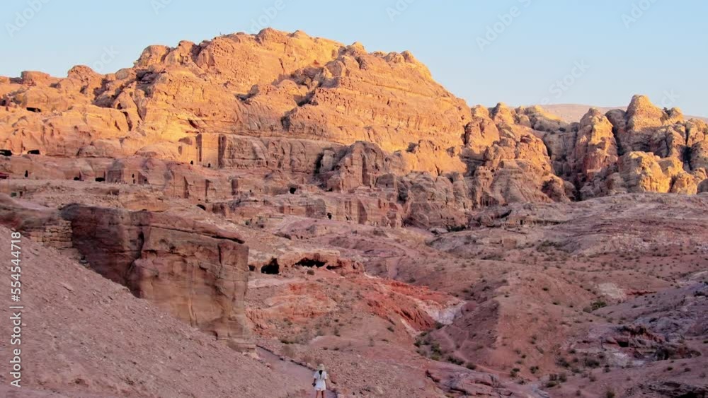 Female caucasian tourists walk around the Petra ruins with famous Al-Khazneh (The Treasury). Female caucasian tourists walk around the Petra ruins with famous Al-Khazneh (The Treasury).