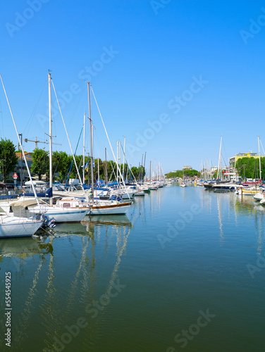 View of Rimini sea port with yachts and blue water. © Trambitski