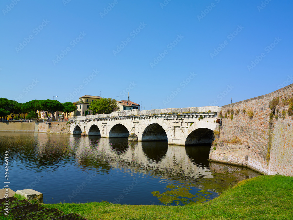 Tiberius bridge in Rimini on a background of blue sky