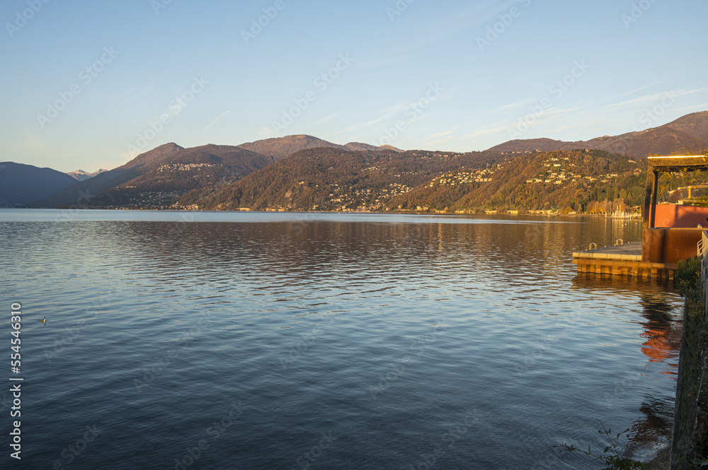 The beautiful lakeside park in Luino in the golden hourwith mountain in backgruond