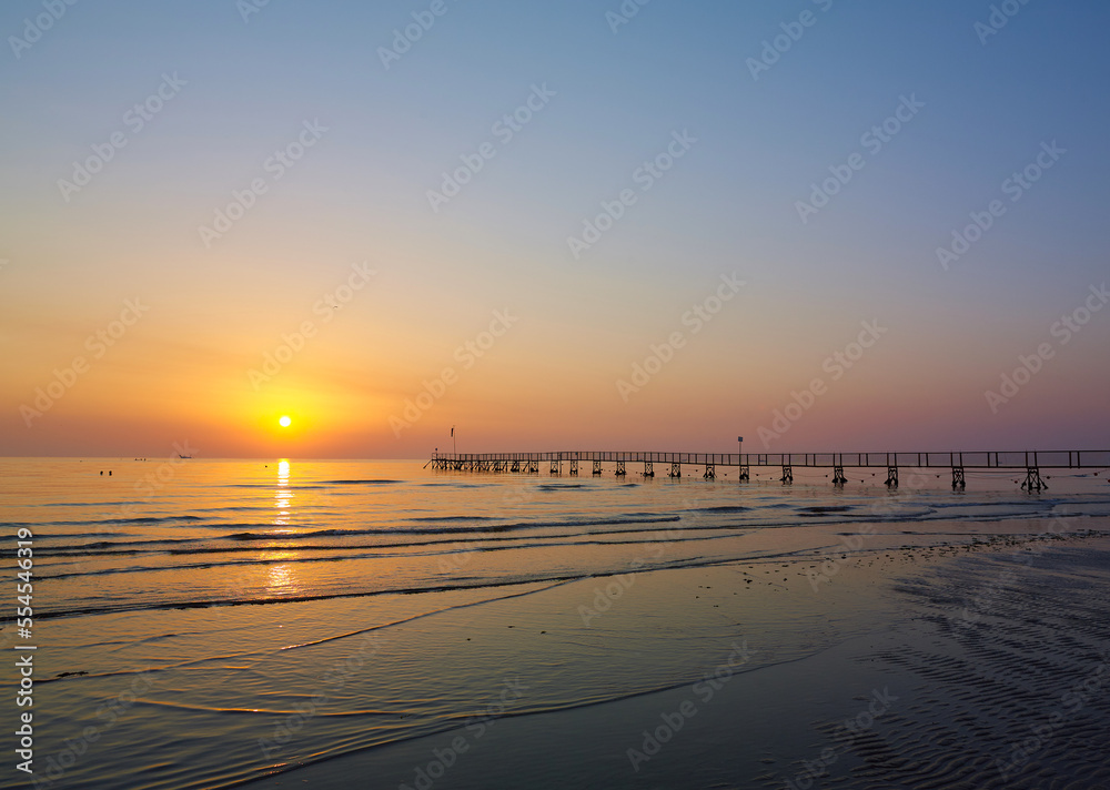 Amazing Sunset on the Sea. Adriatic sea, pier, sunset, waves and landscape.  Rimini, Italy.