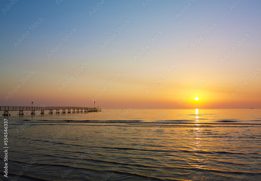 Amazing Sunset on the Sea. Adriatic sea, pier, sunset, waves and landscape.  Rimini, Italy.